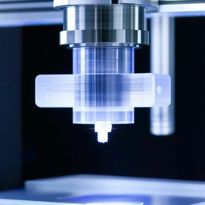 A Machine Is Shown In The Image, With A Clear Plastic Container On Top Of It