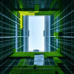 Urban Drone Photography: Skyscraper With Green Rooftop With Large Building